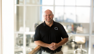 Wesley Keel in a black shirt standing at Quin Global Americas Headquarters